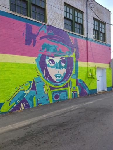 Mural of female astronaut. Seemingly from love death and robots.